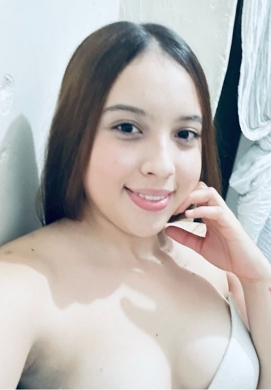 Close-up of a woman smiling warmly at her webcam